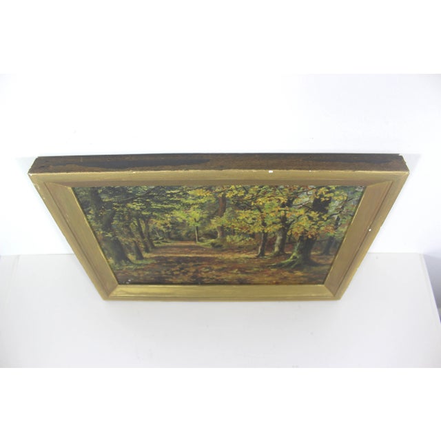 Beautiful antique oil painting of a fall landscape with trees and a laneway. The frame is gold painted wood and has some...