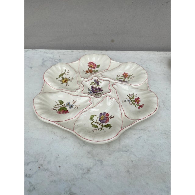 Majolica oyster plate with different flowers on each shells, circa 1900 signed Longchamp.