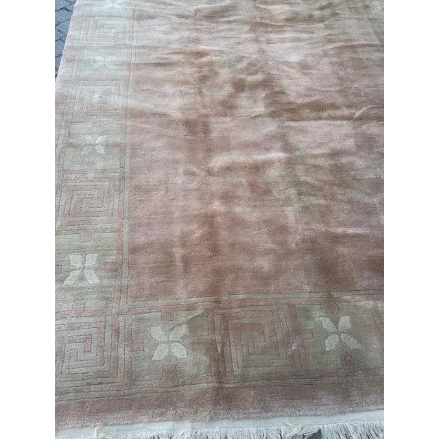 Nice vintage Nepalese rug with a simple geometrical design in borders and light pink colour on field , entirely hand...