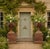 A striking pair of English classical terracotta garden urns, richly ornamented and raised on substantial square plinth...