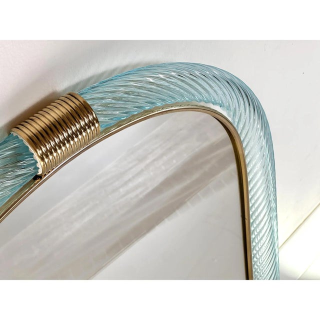 Scenographic wall mirror in brass elements not laquered with light-blue and gold leaf inside working in "torciglione...