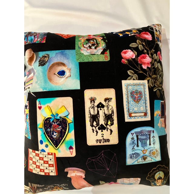 Square pillow, brightly colored playing cards on a black background. The back of the pillow is orange and the pillow is...