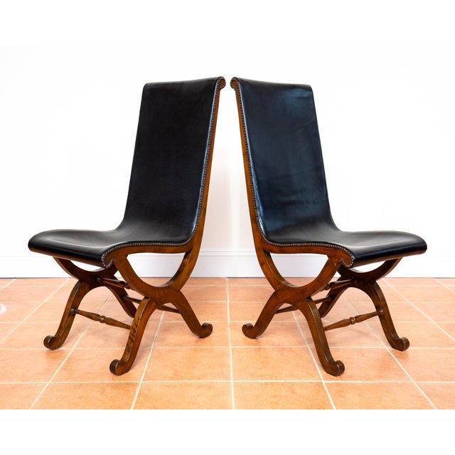 A set of four superb quality, extremely rare and very impressive spanish black leather and oak dining chairs in lovely...