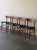Beautiful set of four vintage Danish dining chairs crafted in solid teak with original black leather seats. These chairs...