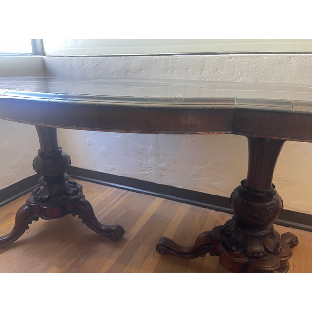 Clover Leaf Pedestal Table in Dark Wood. Ornate leg carvings. The table was well taken care of since purchased in the...