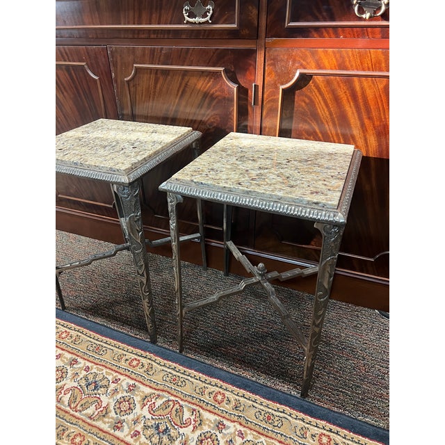 This is a pair of antique neoclassical-style accent tables showcasing distinct European craftsmanship, reminiscent of...