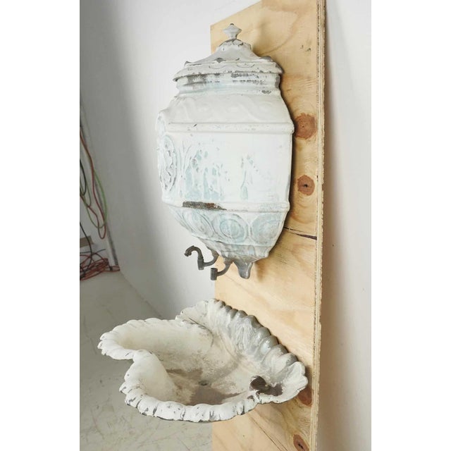 French style lavabo wall fountain made of enameled cast iron. It features a pale powder blue and white powdered enamel...