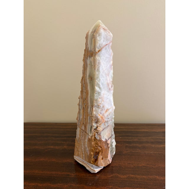 A beautifully proportioned marble obelisk in richly veined shades of green and brown. The sculptural silhouette and...