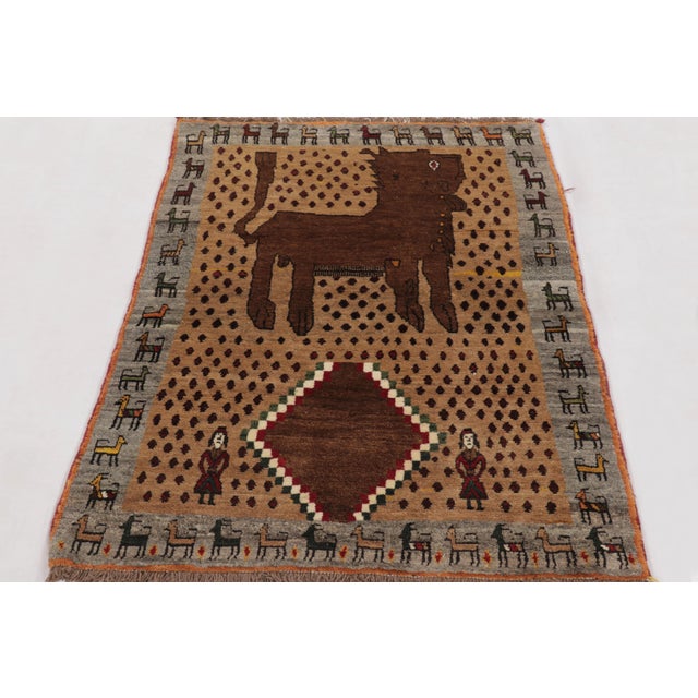 Hand-knotted in wool and originating circa 1950-1959 from Afghanistan, this 3x5 vintage Gabbeh rug joins Rug & Kilim’s...