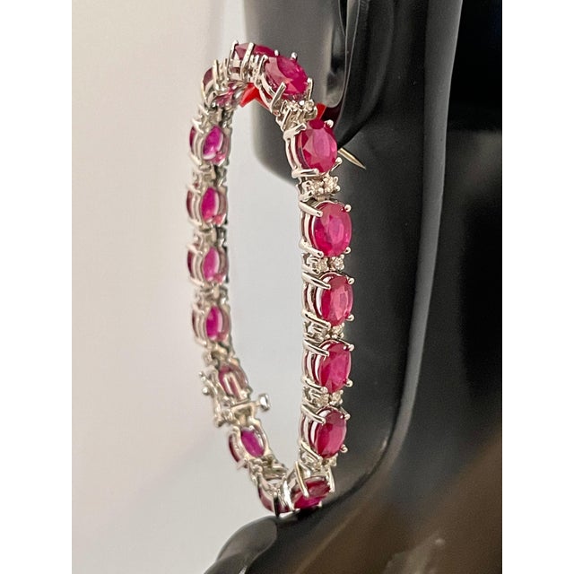 This exceptionally affordable Tennis bracelet has 19 stones of oval Treated Rubies . Ruby is Treated. The weight of the...