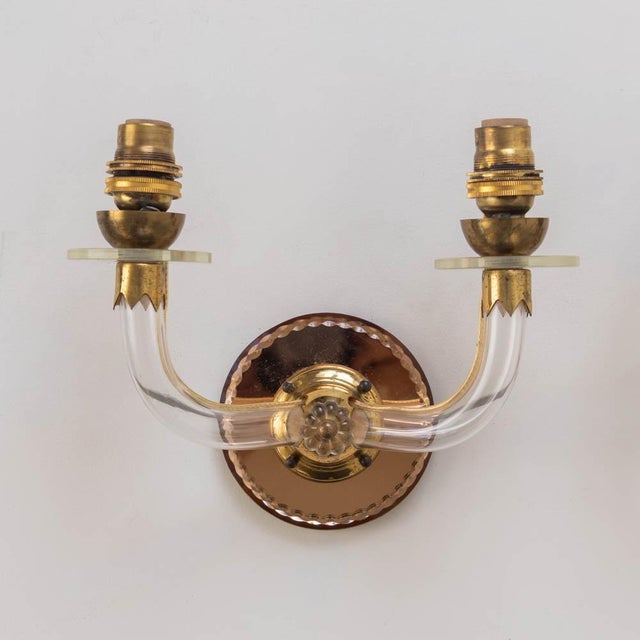 Beautiful pair of Art Deco Lucite two arm sconces from France, 1930s. Curved Lucite arms with lovely brass detail. Newly...