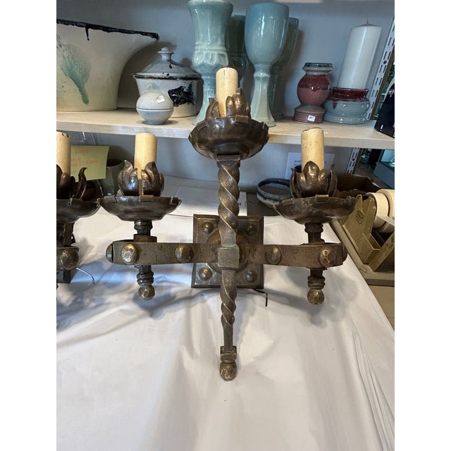 Sensational gutsy pair of heavy antique French 3 arm sconces having gothic inspired details. Newly rewired. (Joyce)