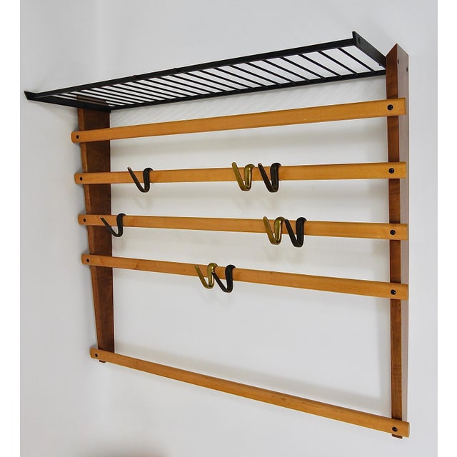 An elegant modernist wall-mounted coat rack from the 1950s. An original and old vintage object, designed and executed by...
