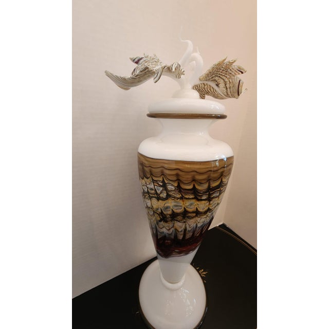 This Cremation Urn is a beautiful hand-blown glass urn formed and created to be one of a kind for your special loved one...