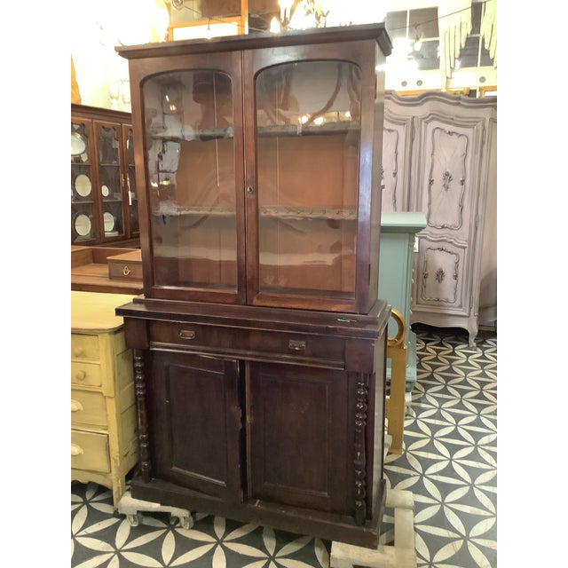 This antique apothecary-style cabinet is full of timeless character and charm. Crafted from rich dark wood, it features a...