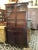 This antique apothecary-style cabinet is full of timeless character and charm. Crafted from rich dark wood, it features a...