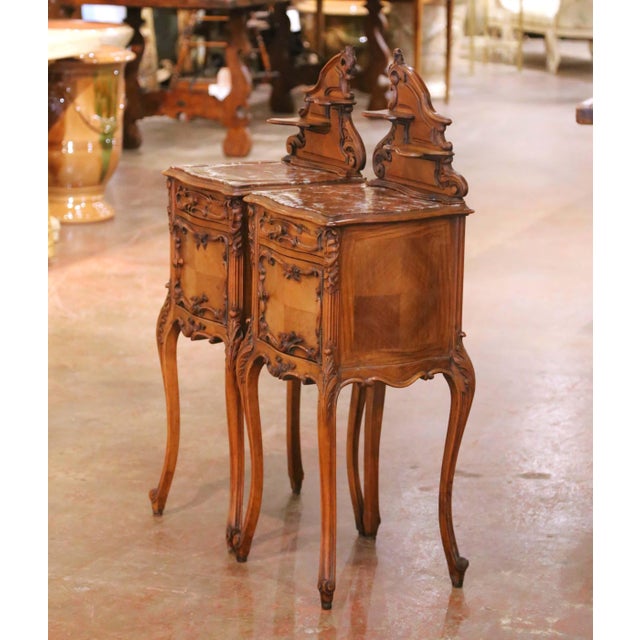 This elegant pair of antique French nightstands was crafted circa 1920 and reflects the graceful curves and refined...