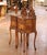 This elegant pair of antique French nightstands was crafted circa 1920 and reflects the graceful curves and refined...