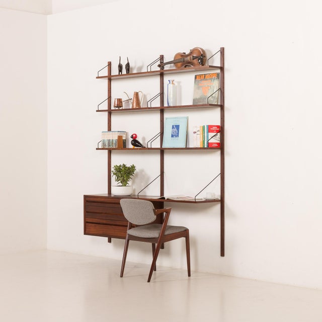 The extremely elegant rosewood wall unit was designed by poul cadovius and made by cado in the 1960s. The simplicity is...