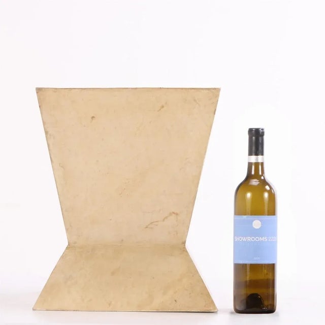 The basket has a sculptural, geometric silhouette wrapped in hand-dyed parchment. The angular design lends an accent of...