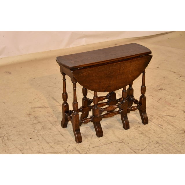 19th century oak gate leg table from England. This table has a nicely grained top, following down to a simple apron and...