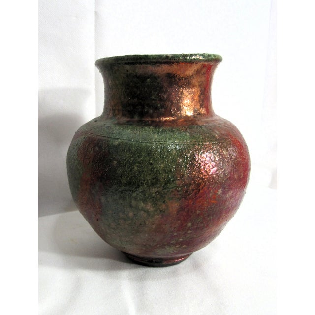 This is a piece of Raku studio pottery, some iridescent qualities as shown in photos. Sweet rustic little pot is...
