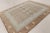 This 8x10 contemporary Art Deco rug showcases a sophisticated geometric pattern in light blue, beige, and earthy brown...