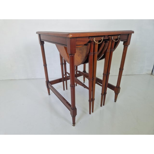 Beautiful set of mahogany nesting tables. Under the square table are two round foldable tables that have a diameter of 43...