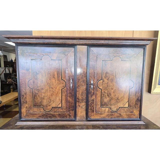 Spectacular large burl walnut double door top and bottom cabinet. This 17th century piece is most likely Flemish, Germanic...