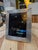 A rectangular picture frame with a polished silver-tone finish and layered, stepped borders. Subtle corner details add...