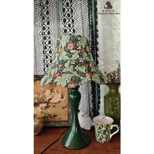 Shade is navy-based retro floral fabric (rich plant pattern, wave-edge design), body is glossy dark green ceramic (elegant...