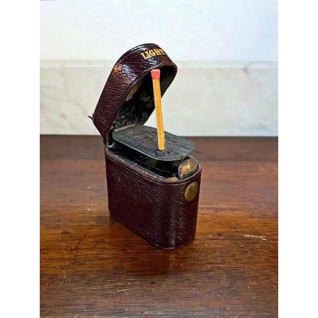 Art Deco Automatic Strike Vesta Lighter, circa 1925 Material: Brass, Leather, Steel A charming early 20th century...