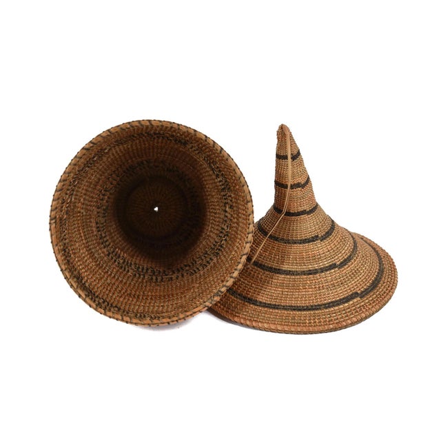 The Tutsi Tight Weave Basket with Lid from Rwanda epitomizes the artistry and tradition of the Tutsi community's weaving...