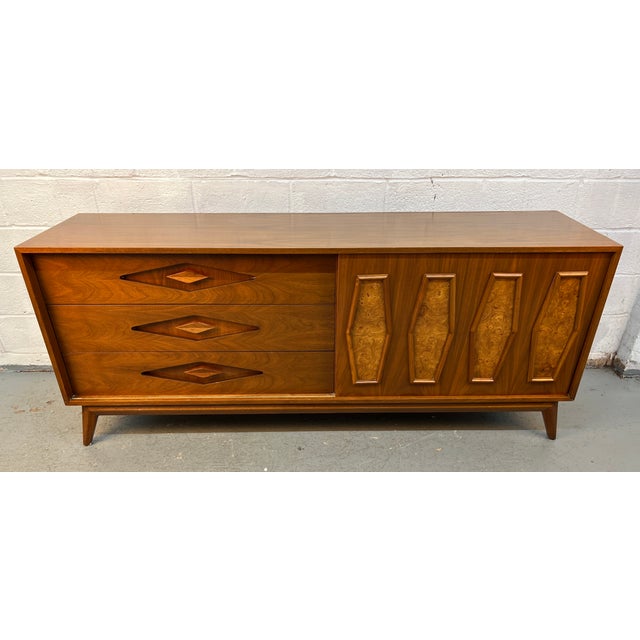 A striking example of mid-century modern design, this walnut credenza showcases bold geometric styling and exceptional...