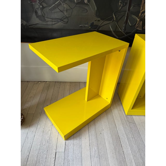 Pair of vintage C.2010 CB2 lacquered bright yellow side tables with wheels. Solid structure. Heavy weight.