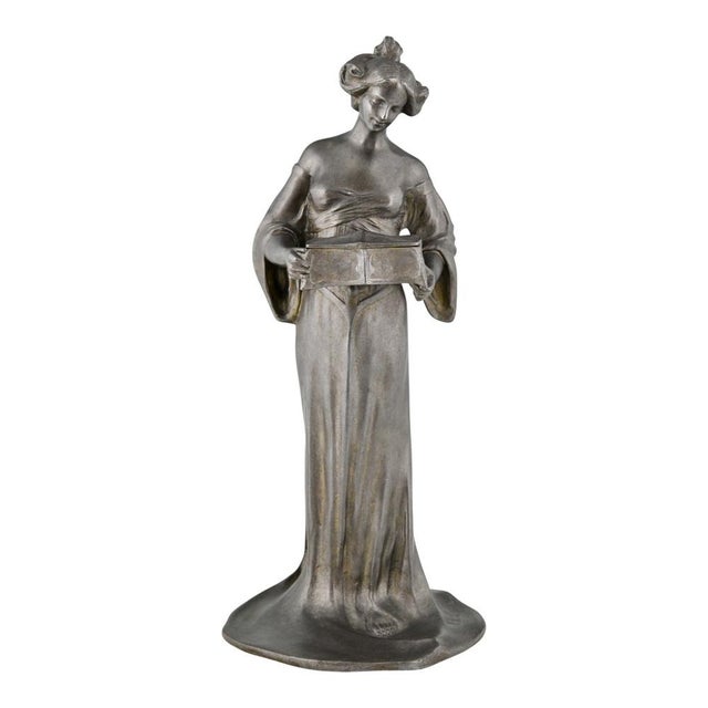 Exquisite Art Nouveau sculpture of a lady holding a casket, created by French artist Louis Octave Mattei (1877-1918)....