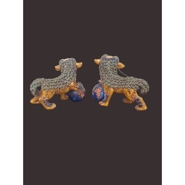 Vintage polychrome pair of detailed clay foo dogs.