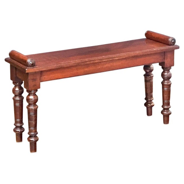 A fine English hall bench or window seat or stool of mahogany from the Edwardian era, featuring roll-end bolsters at...