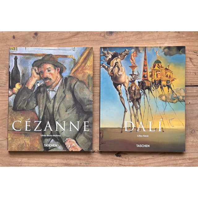 Set of two Taschen art books featuring master painters Paul Cézanne and Salvador Dalí. This curated pair brings together...