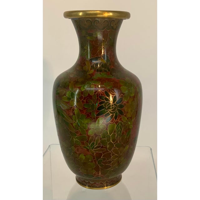 Beautiful earthy tones on this vintage Chinese cloisonné vase. Intricate floral pattern accented with gold tone brass rims.