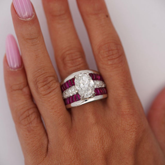 A GIA-certified 4.43 carat oval brilliant diamond in G color and I1 clarity is four-prong set in a platinum 900 wide dome...