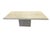 The table features a rectangular granite top with a soft, weathered finish in light beige and taupe tones. The surface has...