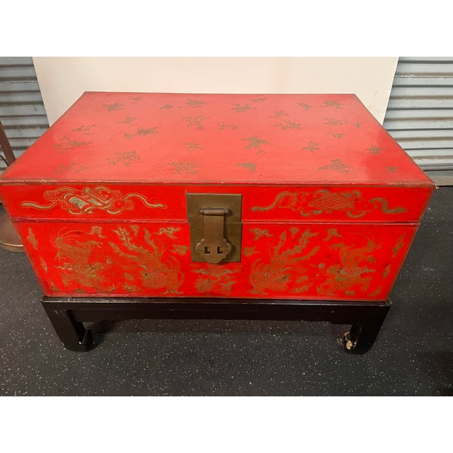 Antique Chinese Red Lacquer and Gilt Trunk on black lacquer wood Stand. Hand painted with high quality lacquer. Features a...