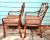 A classic pair of 1980s Chinese Chippendale-style armchairs featuring faux bamboo frames, lattice backs, and original cane...