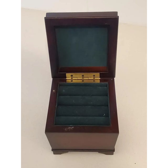 Lovely and practical small vintage wooden jewelry music box plays sweet melody when wound up. Lined with dark green...