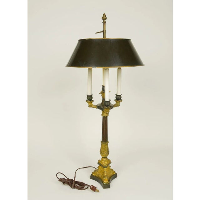 Of columnar form enriched with acanthus leave decoration, issuing three candlearms fitted with electrified candlesleeves,...