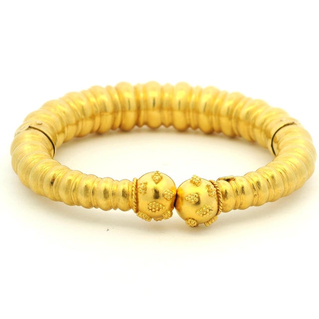 A striking circa-1970 bracelet by celebrated Greek goldsmith Ilias Lalaounis, handcrafted in richly hued 22-karat yellow...
