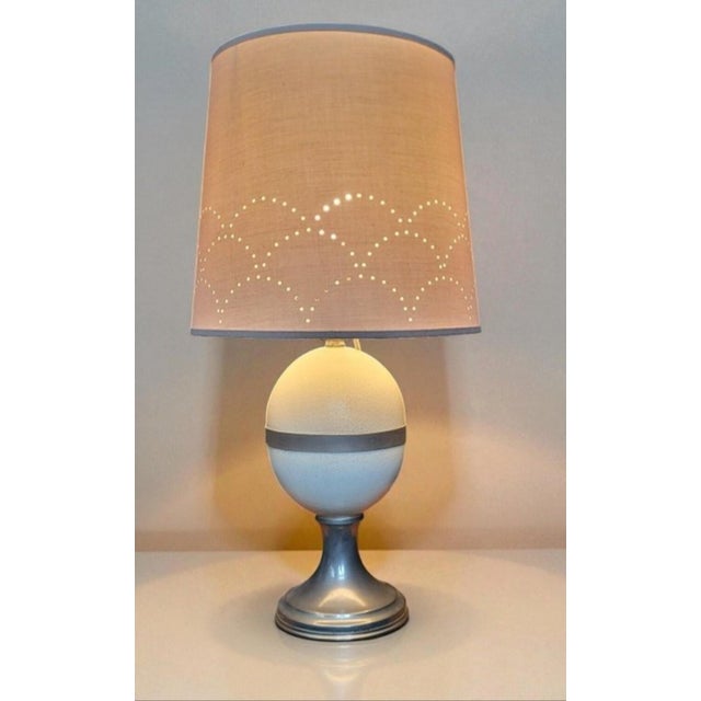 Ostrich Egg Lamp by Christian Dior / Perforated lampshade. Chrome-plated metal base. Height 48.5 cm Lampshade diameter 25...