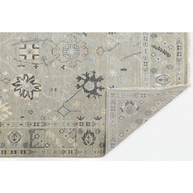 Elevate your living space with this sophisticated Modern Oushak style rug, hand-knotted from highland wool for durability...
