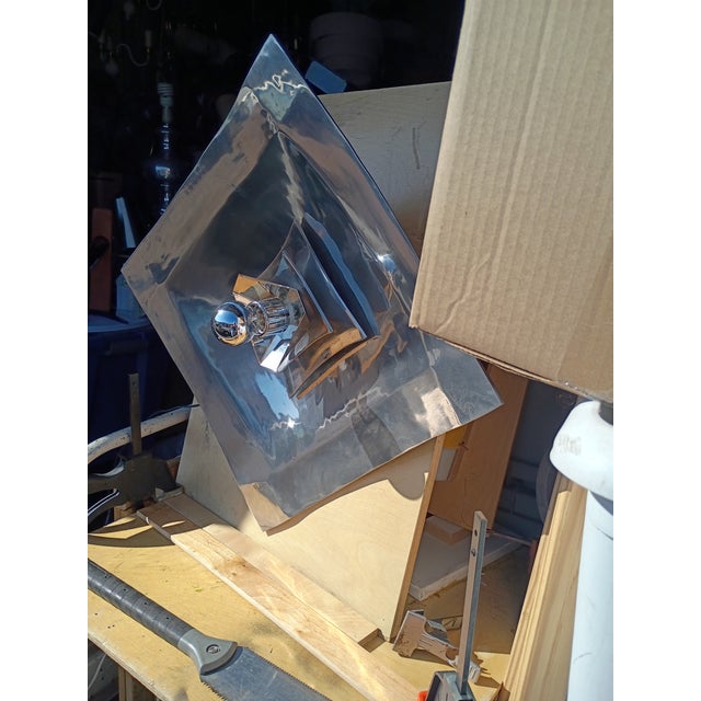 This silver plate and polished aluminum wall light can also be hung as a corner lamp and ceiling lamp it's 27" by 27 and...